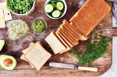 sliced bread, avocado and other ingredients on a cutting board