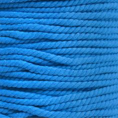 a spool of blue rope is shown in this close up photo, with the thread on