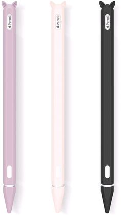 three different colored pens lined up next to each other on a white surface, one black and one pink