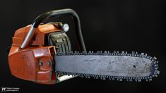 an orange chainsaw on a black background with clippings to show the blades