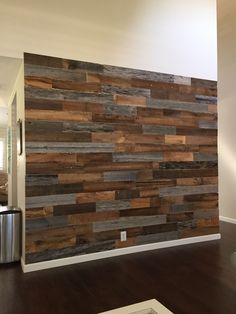 a living room with wood paneling on the wall