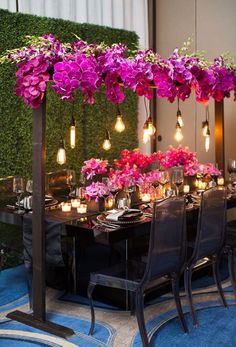 an image of a table with flowers on it and candles in vases at the center