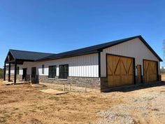 a horse barn is being built in the middle of an open field with no grass