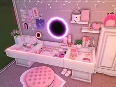 a bathroom with pink accessories and lights on the wall, along with a vanity table