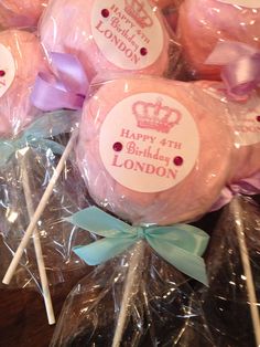 pink lollipops wrapped in plastic wrappers with bows