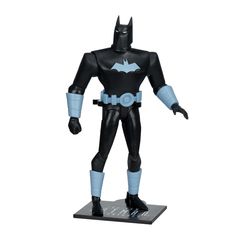 the batman action figure is posed on top of a black base with light blue accents