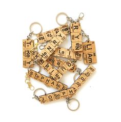 wooden key chains with letters and numbers are shown on a white background in this image