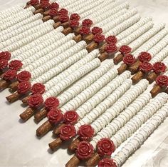 several rows of wine corks with red roses on them, arranged in the shape of flowers