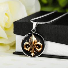 "🌘MESSAGE CARD🌒 Let the presence of the Fleur de Lis transport you to an era of grandeur and opulence, where craftsmanship and artistic expression flourished, and where the spirit of nobility still resonates today. 🌘JEWELLERY DESCRIPTION🌒 Embrace the elegance of French Royalty with our stunning Fleur de Lis graphic pendants. Our Fleur de Lis jewelry masterfully captures the regal charm and timeless sophistication of this iconic symbol. Each piece is intricately crafted from surgical steel, f Elegant Commemorative Medallion Jewelry, Elegant Round Pendant Necklace For Commemoration, Formal Symbolic Round Necklace, Elegant Silver Jewelry For Commemoration, Symbolic Round Necklace For Formal Occasions, Elegant White Gold Necklace For Commemoration, Vintage Necklace With Polished Finish For Gift, Elegant Engraved Jewelry For Commemorations, Elegant Engraved Jewelry For Commemoration