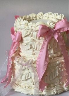 a cake that has been decorated with pink ribbon