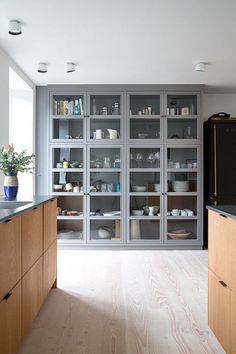 a kitchen filled with lots of wooden cabinets