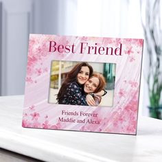 a pink frame with the words best friend on it and an image of two women hugging each other