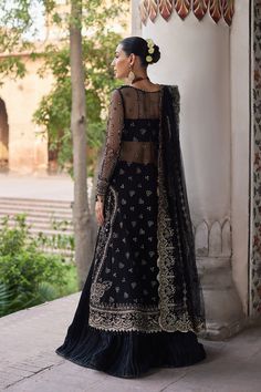 Traditional Black Embroidered Pakistani Wedding Dress Gown Sharara is an elegant attire that is adorned with silver details, zardosi, pearls, and threads. Lavish designs and the premium quality of the fabric make this Sharara Dress an epitome of beauty and grace. Pakistani Kameez Gown: The kameez is beautifully adorned with hand-crafted details of embroidery, dabka, Sequins, and Threads. Tilla, silverwork, and shimmering silver details on this grey-colored front open kameez make it a perfect cho Net Design, Pakistani Wedding Dress, Net Dress, Readymade Saree, Chiffon Collection, Elegant Attire, Embroidered Dupatta, Clothing Websites, Silk Dyeing