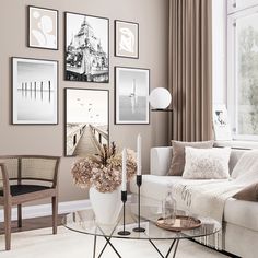 a living room filled with furniture and pictures hanging on the wall above a coffee table