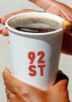 a woman holding a cup with the number 921 on it