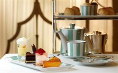 a table topped with plates and cups filled with desserts