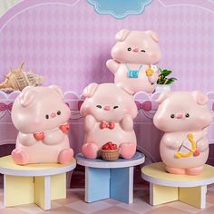 three little pig figurines sitting on small stools in front of a pink wall