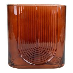 a brown glass vase sitting on top of a table