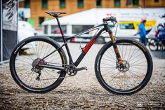 the bike is parked on the gravel by itself