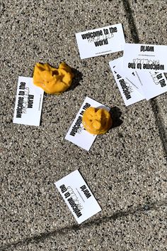 several pieces of paper with stickers on them laying on the ground next to each other