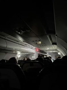 the inside of an airplane with people sitting in it