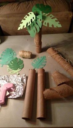 a table topped with lots of different types of paper cut outs and palm tree decorations