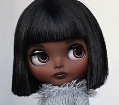 a doll with black hair and brown eyes