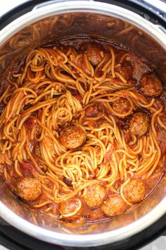 spaghetti and meatballs are cooked in the crock pot for an easy dinner recipe