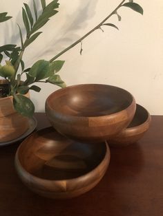 three wooden bowls sitting on top of a table