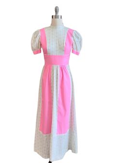 This dress is so Darling! Vintage 1970's prairie style dress with tiny floral print against a pop of bright pink! Short puffy sleeves with ribbon tie back. Material is a soft cotton Dress appears to be hand sewn is well made and in good condition  Best for size small  Bust- 34" Waist- 26" Length- 55" Sleeve- 10" Pink Puff Sleeve Fitted Maxi Dress, Pink Fitted Puff Sleeve Maxi Dress, Pink Fitted Maxi Dress With Puff Sleeves, Fitted Pink Maxi Dress With Puff Sleeves, Pink Maxi Dress With Square Neck For Garden Party, Pink Puff Sleeve Maxi Dress For Spring, Vintage Pink Maxi Dress For Garden Party, Vintage Pink Prairie Dress For Summer, Pink Cotton Vintage Dress For Garden Party