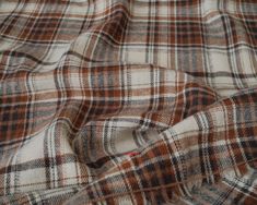 the fabric is brown and white plaid