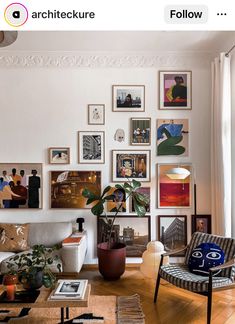 a living room filled with furniture and pictures on the wall