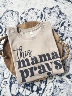 THIS MAMA PRAYS in tan🖤 Unisex fit Brand: Bella and canvas Best Selling Shirt Designs, Easy Shirt Designs, Christian Mama Shirts, This Mama Prays, Cricut Vinyl Shirts, Christian Mom Shirts, Christian Tshirt Design Ideas Vinyl, Jesus Tshirt Design, Mom Sayings For Shirts