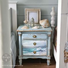 an old dresser painted with seashells on it