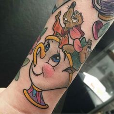 an arm with a cartoon character tattoo on it