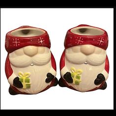 two red and white santa claus salt and pepper shakers with bows on their heads