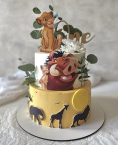 the lion king cake is decorated with fondant and edible decorations, including fake flowers