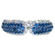 This exquisite, handmade bracelet by Van Cleef & Arpels is a masterful work of art. Featuring a dazzling assortment of 132 blue sapphires of graduated sizes (ranging from 3.5 mm - 5.0 mm each) and 92 round brilliant cut diamonds = approximately 20.00 carat total weight, this high jewelry piece is an incredible addition any fine jewelry collection. Bracelet possesses a push button tongue clasp with safety plunge and safety chain installation. Purchase includes original Van Cleef & Arpels pouch. High Jewelry Bracelet, Platinum Bracelet, Van Cleef & Arpels, Modern Bracelets, Van Cleef And Arpels, Van Cleef, Van Cleef Arpels, Sapphire Bracelet, Fine Jewelry Collection