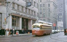 an old photo of a trolley on the street