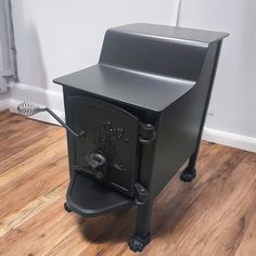 a black stove sitting on top of a hard wood floor