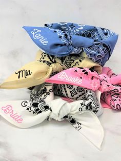 several different types of hair bows on a white surface with the word bride printed on them