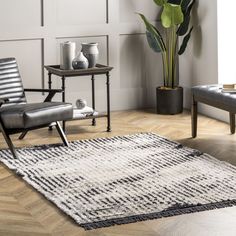 a living room with two chairs and a rug