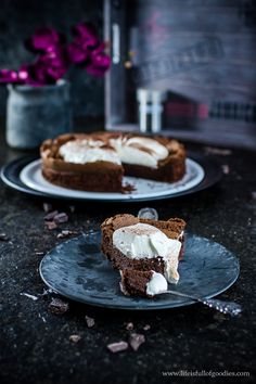 two plates with slices of cake on them sitting on a table next to each other