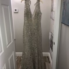 a dress hanging on a hanger next to a door