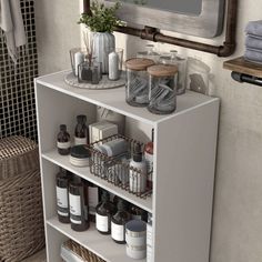 a white shelf filled with lots of bottles next to a mirror and wicker basket