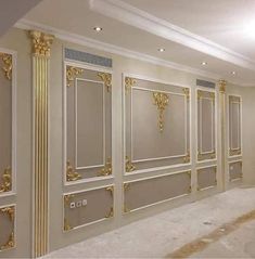 an empty room with white walls and gold trimmings on the doors, along with carpeted flooring