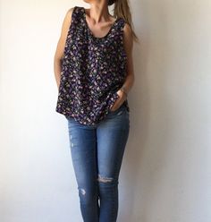 ⚡️Free shipping when you spend 100€⚡️ ⚡️Beautiful vintage sleeveless blouse, top with floral print, navy blue color with violet, dark pink and green flowers and leafs. ⚡️In excellent vintage condition. ⚡️ Fits best- S-M-L. ⚡️Reference model size M, height - 178 cm, weight - 60 kg. ⚡️Measurements: - Armpit to armpit, flat taken: 21,6 inch // 55 cm. - Length from armpit to bottom: 15 inch // 38 cm. - Length: 25,6 inch // 65 cm. ⚡️All items come from a smoke free home. ⚡️Please write me your phone Patterned Sleeveless Top With Floral Print, Patterned Floral Print Sleeveless Tops, Printed Sleeveless Cotton Blouse, Sleeveless Patterned Blouse For Spring, Casual Patterned Sleeveless Blouse, Printed Cotton Sleeveless Blouse, Patterned Sleeveless Cotton Blouse, Patterned Sleeveless Summer Blouse, Chic Printed Sleeveless Blouse