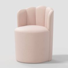 a pink chair sitting on top of a white floor