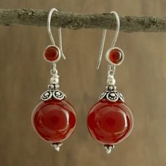 Believed to mirror the sun's energy carnelian the birthstone of July glows with fiery beauty in earrings by Narayani. Sterling silver settings reflect Indian elegance in earrings that are crafted by hand in India. .925 Sterling silver Agate Drop Earrings, Elegant Carnelian Earrings, Elegant Carnelian Drop Earrings, Round Carnelian Earrings, Red Agate Earrings For Gift, Red Carnelian Earrings Perfect As A Gift, Red Agate Earrings As Gift, Elegant Silver Agate Earrings, Bohemian Round Agate Earrings