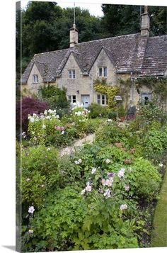 an english country house surrounded by flowers and greenery